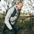 Man hiking through a forest with a blurred background