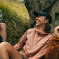 Woman laughing wearing Montane Featherlite Hooded Jacket Pink lay