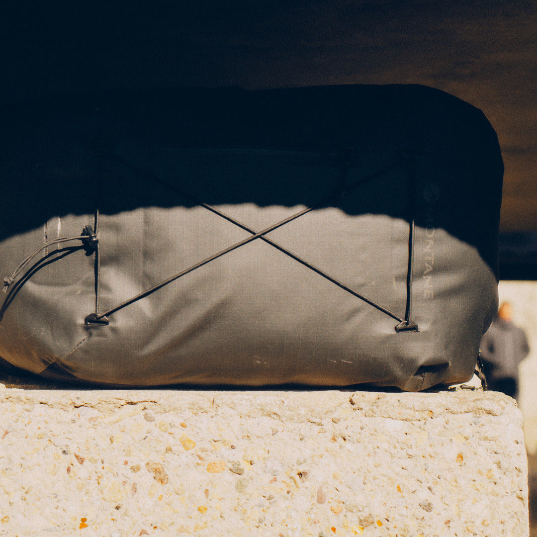 Montane Transition Pack on a stone surface with a blurred background